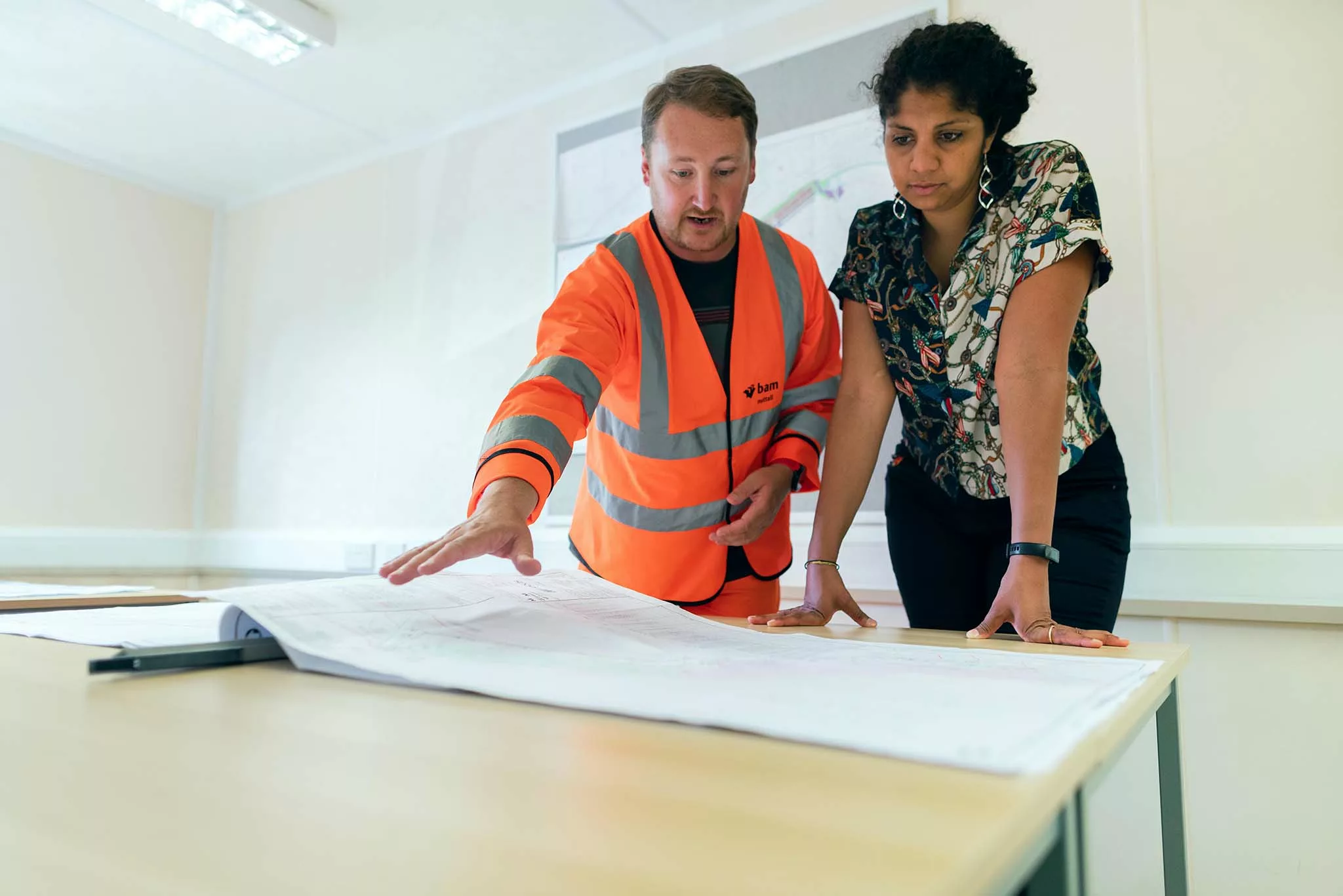 People looking at a blueprint